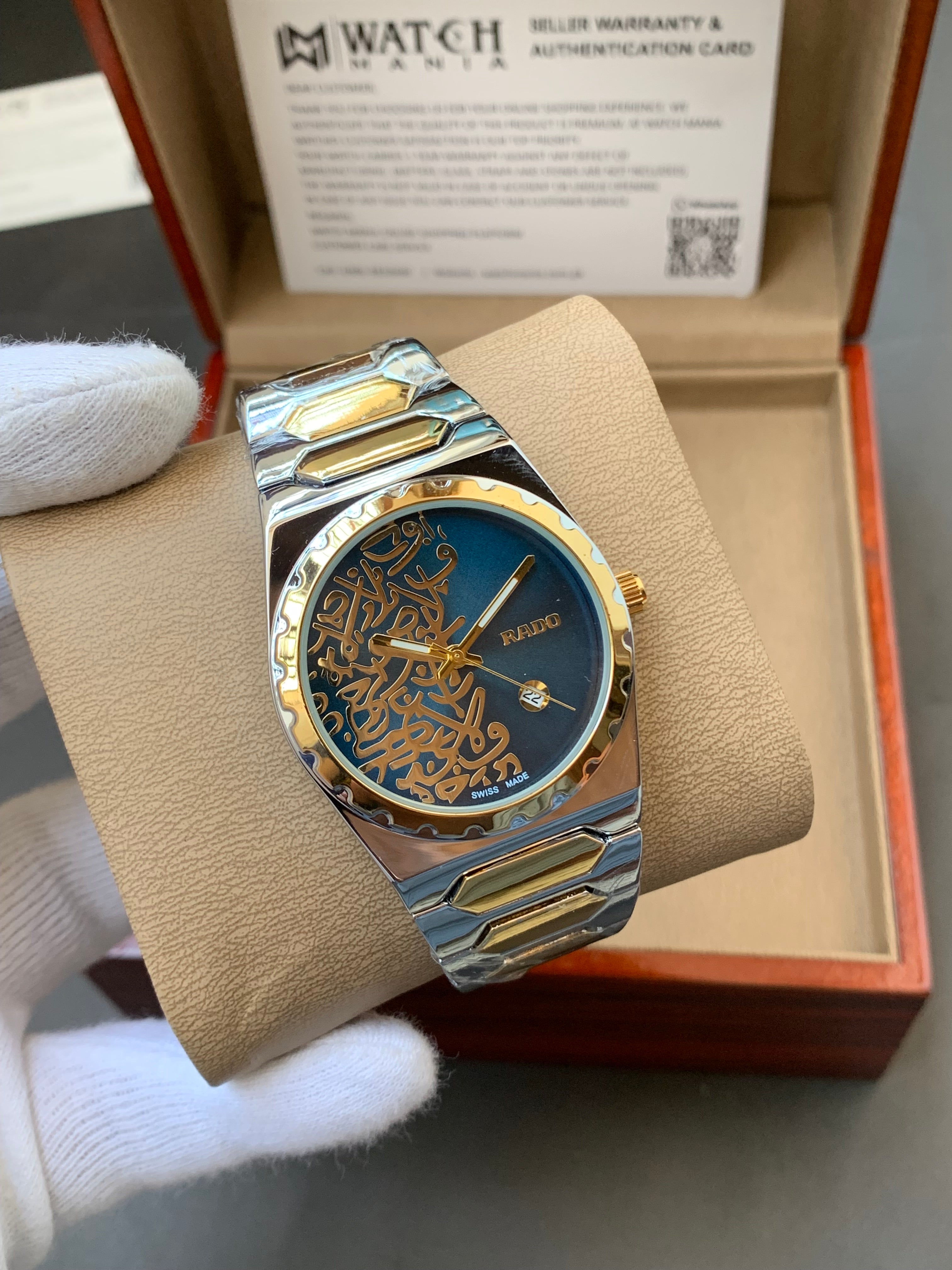 Luxury watch with intricate design on a beige cushion in front of an open box.