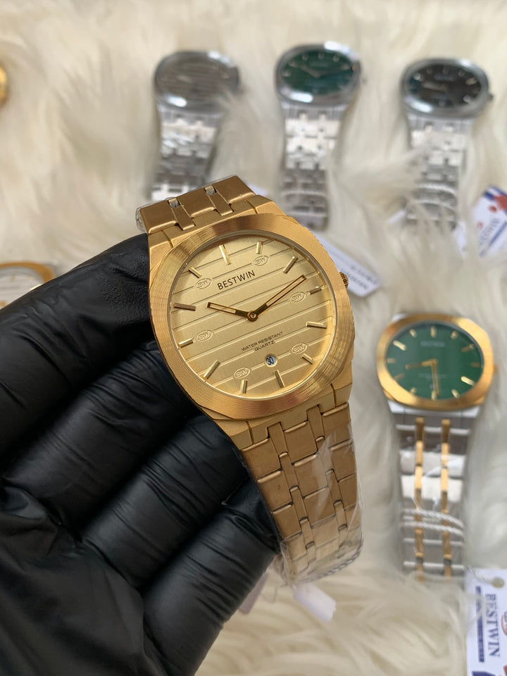 Gold watch held by a gloved hand with blurred watches in the background